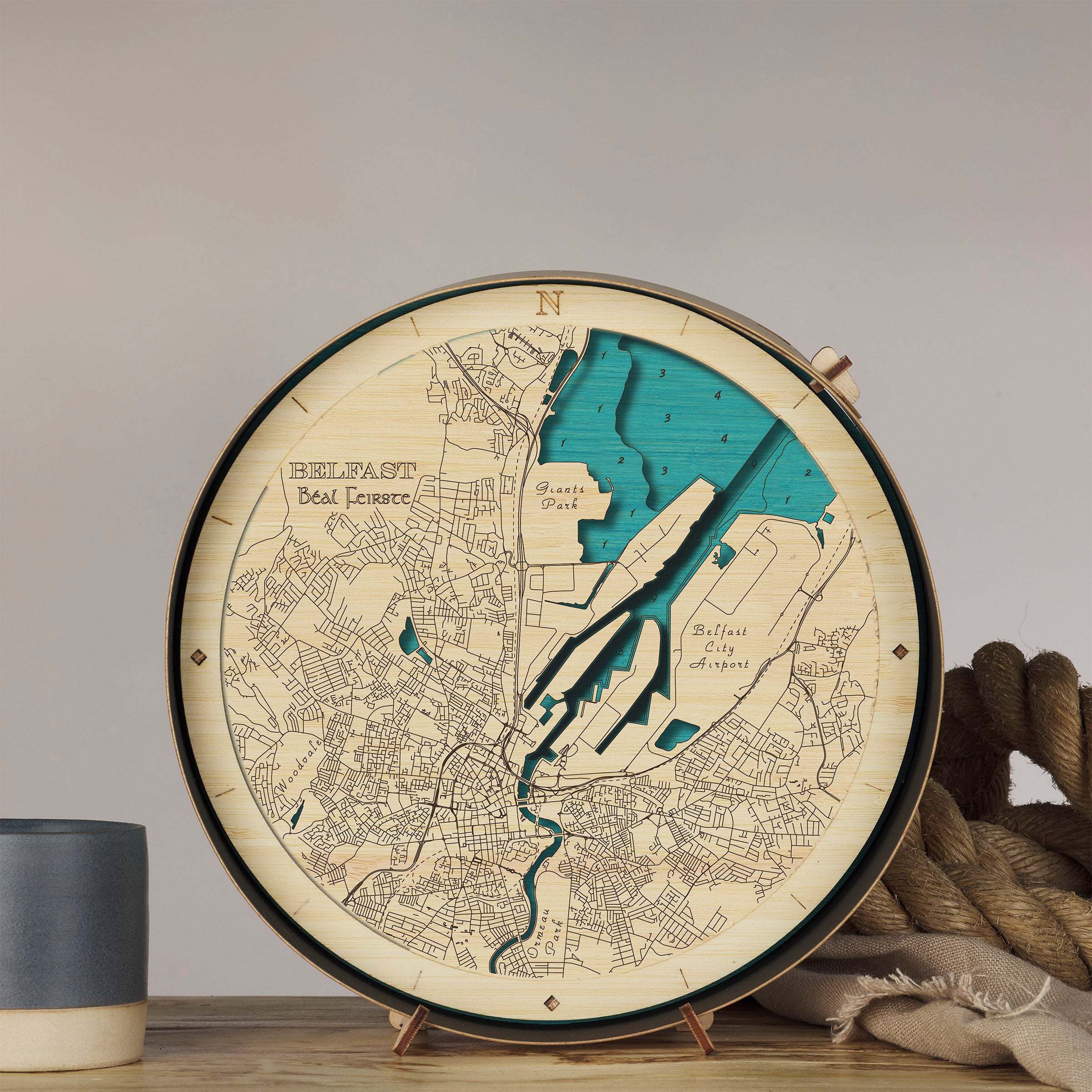 Wooden map of Belfast on a stand with a neutral background