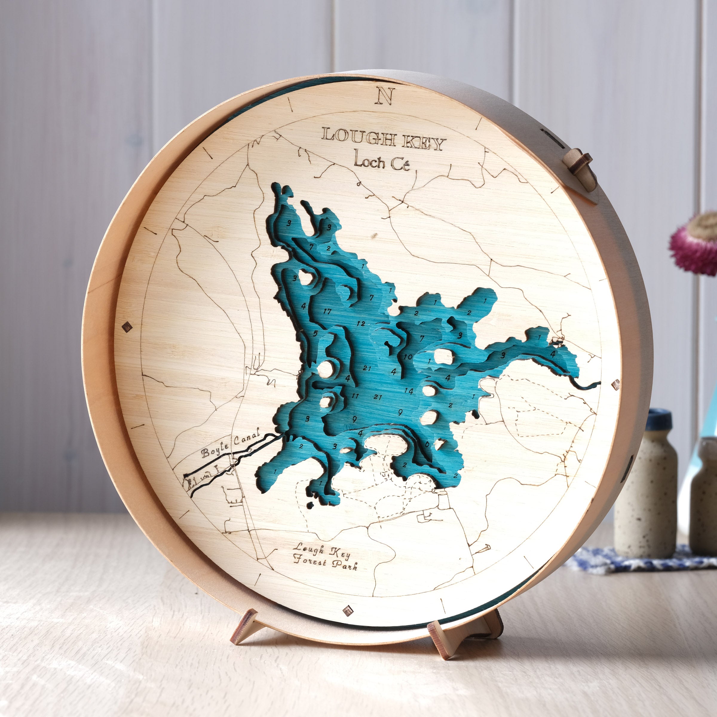 Wooden map model of Lough Key with a lighted background